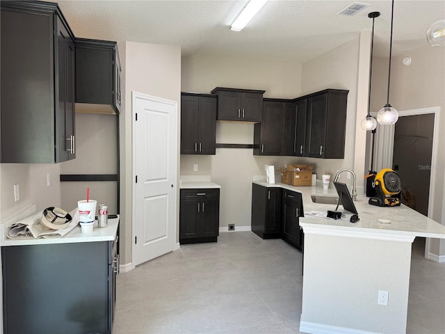 5359 NW 55th Pl, Ocala, FL 34482 - kitchen featuring a sink, a peninsula, pendant lighting, light stone countertops, and light tile patterned floors