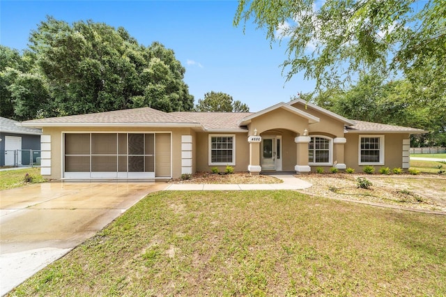 4886 NW 30th Pl, Ocala, FL 34482 - single story home with stucco siding, concrete driveway, a front lawn, and an attached garage