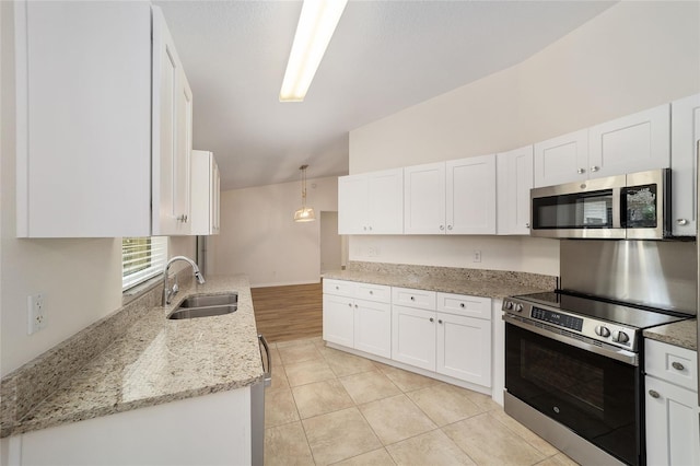 4886 NW 30th Pl, Ocala, FL 34482 - kitchen featuring stainless steel appliances, a sink, white cabinetry, light stone countertops, and lofted ceiling
