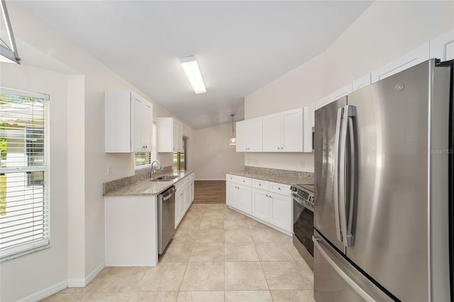 4886 NW 30th Pl, Ocala, FL 34482 - kitchen with stainless steel appliances, a sink, white cabinetry, light stone counters, and baseboards