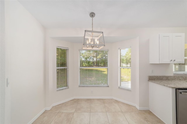 4886 NW 30th Pl, Ocala, FL 34482 - unfurnished dining area featuring a chandelier, light tile patterned floors, and baseboards
