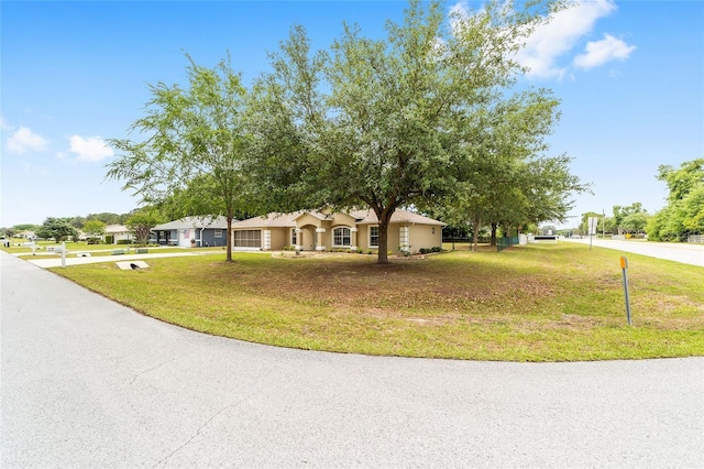4886 NW 30th Pl, Ocala, FL 34482 - ranch-style house with a garage, driveway, and a front lawn