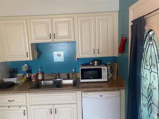 9920 SW 102nd Pl, Ocala, FL 34481 - kitchen with white appliances, a sink, dark countertops, and cream cabinets