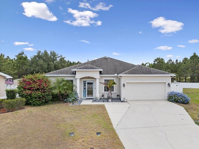 808 Overlook Grove Dr, Winter Haven, FL 33884 - view of front of house with stucco siding, a garage, concrete driveway, and roof with shingles