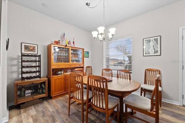 808 Overlook Grove Dr, Winter Haven, FL 33884 - dining area featuring wood finished floors, a chandelier, and baseboards