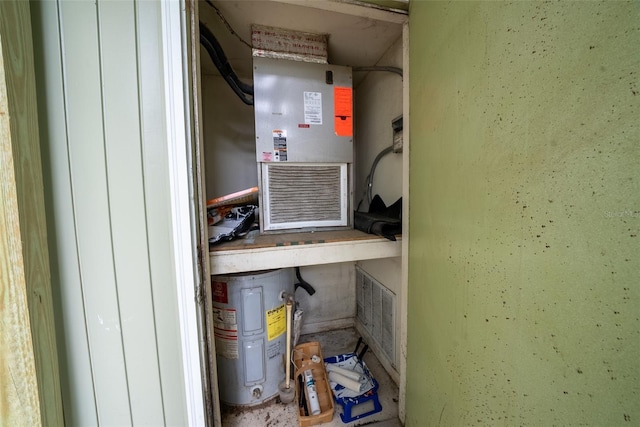 utility room featuring electric water heater and heating unit