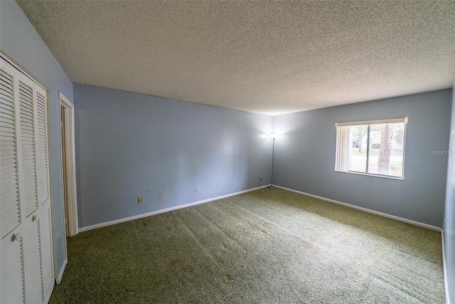 unfurnished bedroom featuring carpet, baseboards, a textured ceiling, and a closet