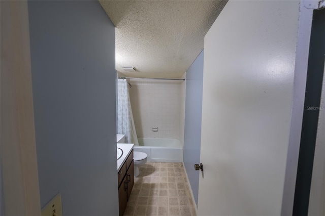 bathroom featuring a textured ceiling, vanity, toilet, and shower / bathtub combination with curtain