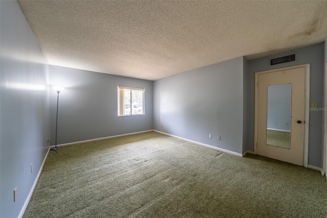 unfurnished room featuring carpet floors, a textured ceiling, and baseboards