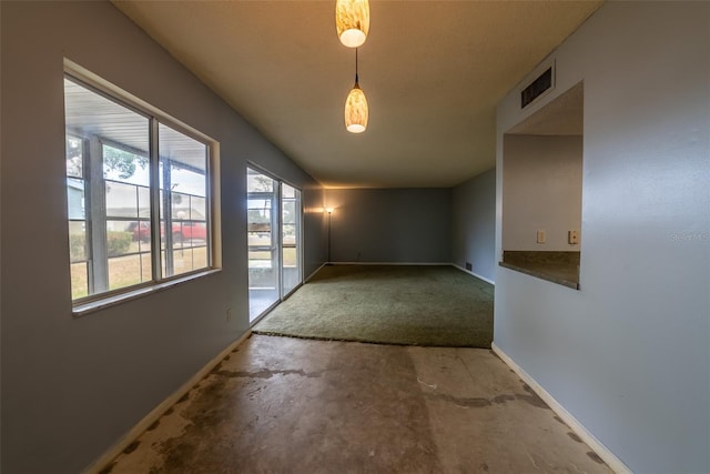 empty room with baseboards and concrete floors