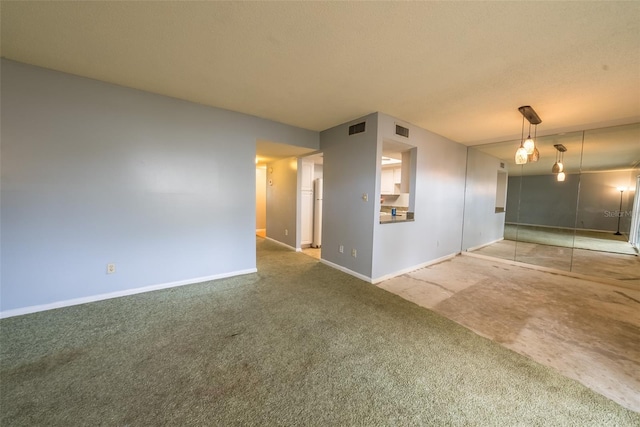 carpeted empty room with baseboards