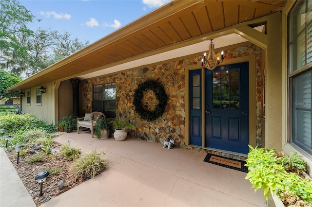 view of exterior entry featuring stone siding