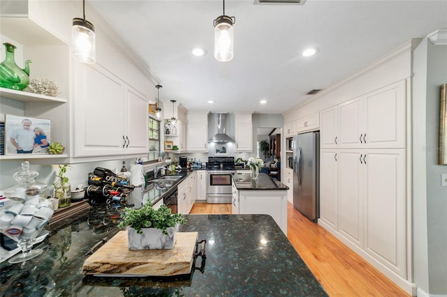 kitchen with appliances with stainless steel finishes, wall chimney exhaust hood, open shelves, white cabinetry, and recessed lighting