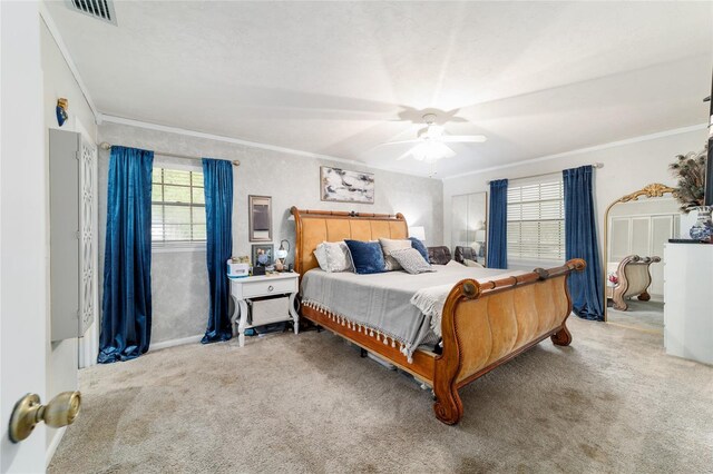 bedroom with carpet floors, ornamental molding, and a ceiling fan