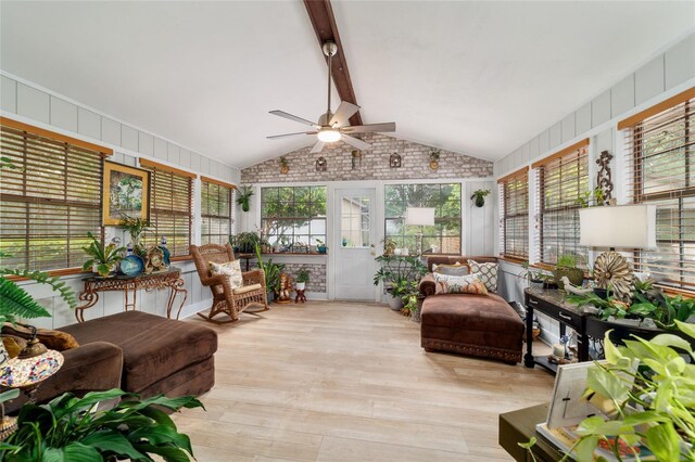 sunroom with a ceiling fan, wood finished floors, and plenty of natural light