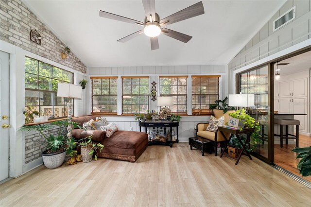 sunroom featuring vaulted ceiling and wood finished floors
