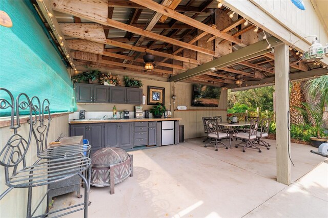 view of patio / terrace with outdoor dining space and a sink