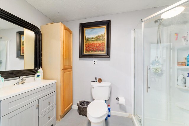 full bathroom featuring a shower stall, vanity, toilet, baseboards, and tile patterned floors