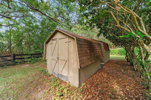 view of shed featuring fence