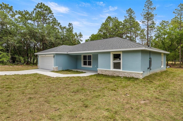 ranch-style house with stucco siding, an attached garage, concrete driveway, stone siding, and a front yard