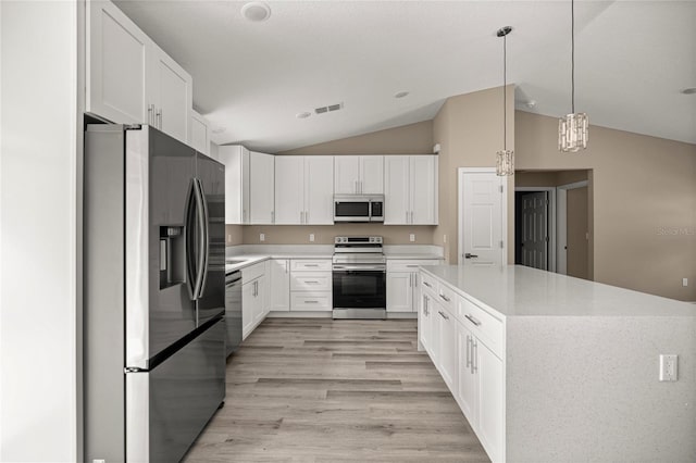 kitchen with stainless steel appliances, lofted ceiling, light countertops, white cabinets, and light wood-style floors