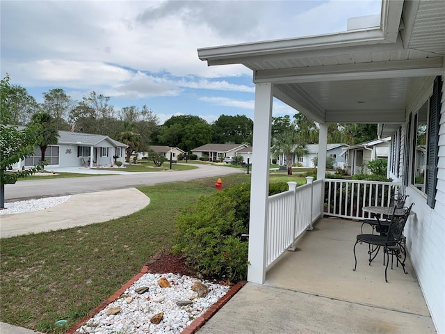 11445 SW 84th Avenue Rd, Ocala, FL 34481 - covered porch with a residential view and a lawn