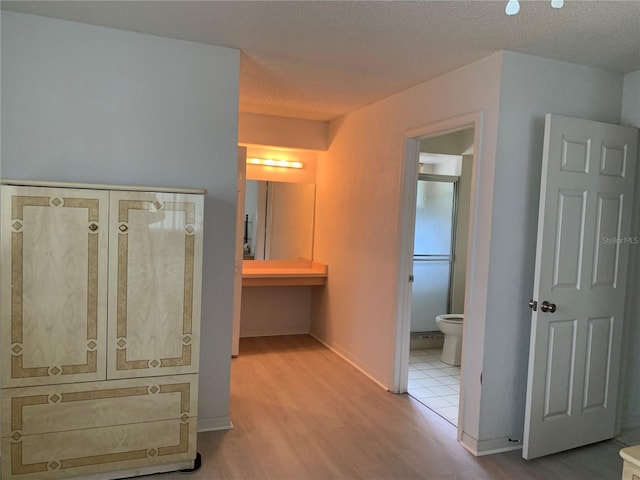 11445 SW 84th Avenue Rd, Ocala, FL 34481 - corridor featuring wood finished floors, a textured ceiling, and baseboards