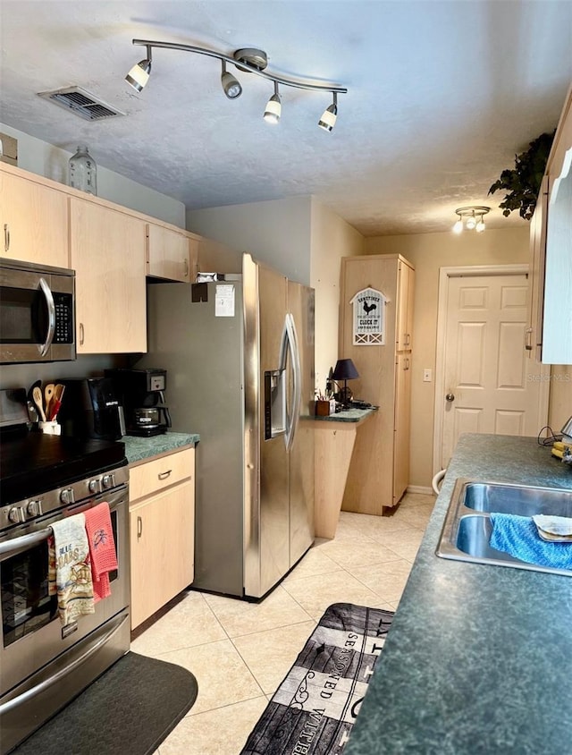 3106 Silver Palm Dr, Edgewater, FL 32141 - kitchen with appliances with stainless steel finishes, a sink, light brown cabinets, and light tile patterned floors