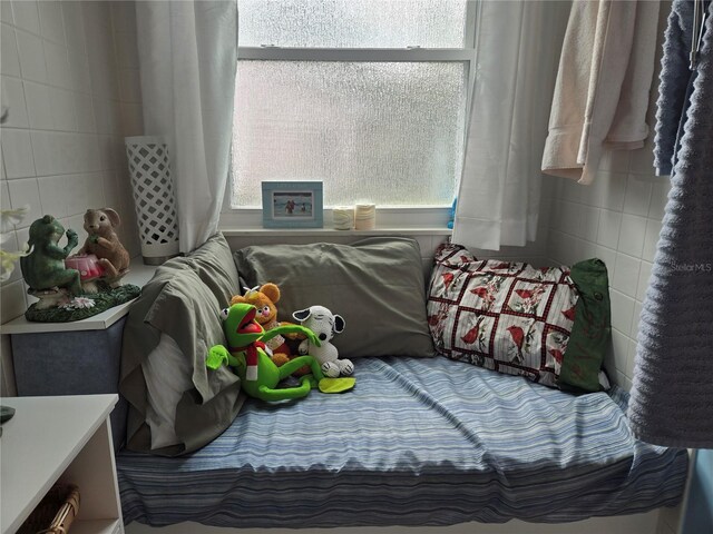 bedroom with tile walls