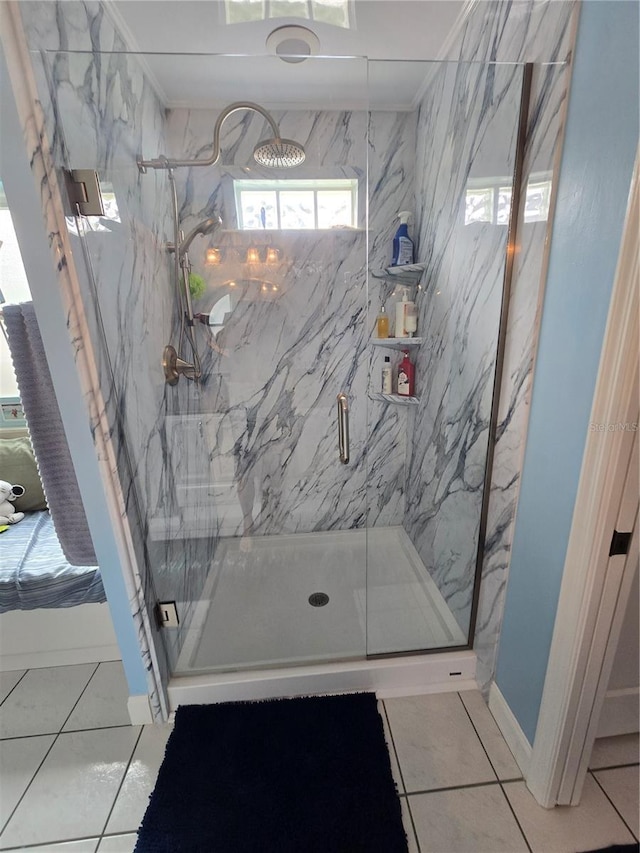 bathroom featuring a marble finish shower, ornamental molding, and tile patterned flooring