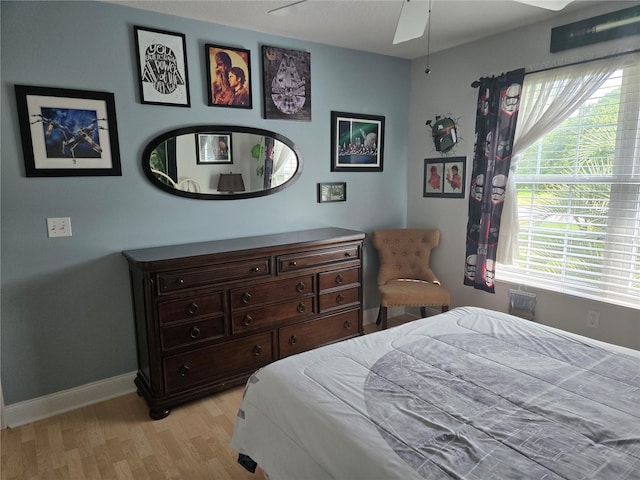 bedroom featuring light wood-type flooring, baseboards, and ceiling fan