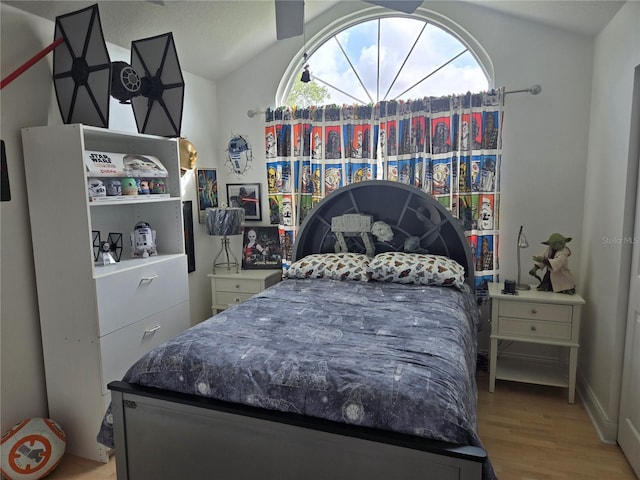 bedroom featuring vaulted ceiling and light wood-style floors