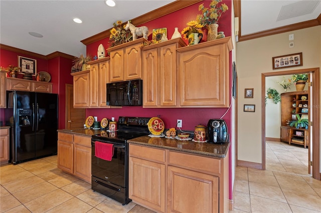 4725 County Road 121d, Wildwood, FL 34785 - kitchen with black appliances, crown molding, light tile patterned flooring, dark stone countertops, and recessed lighting