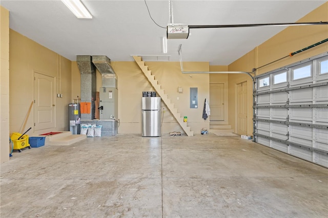 4725 County Road 121d, Wildwood, FL 34785 - garage with electric water heater, a garage door opener, freestanding refrigerator, water heater, and electric panel