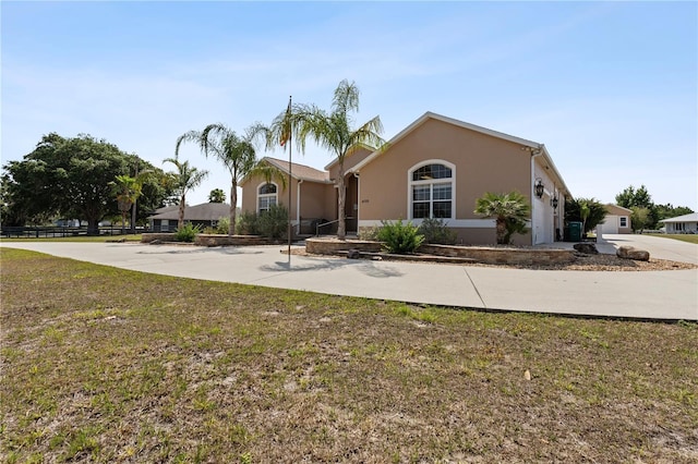 4725 County Road 121d, Wildwood, FL 34785 - view of front of property with stucco siding and a front lawn