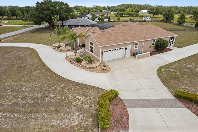 4725 County Road 121d, Wildwood, FL 34785 - view of property exterior with driveway, an attached garage, roof with shingles, and stucco siding