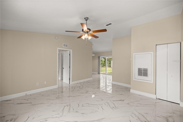 unfurnished room featuring a ceiling fan, baseboards, and light marble finish floors