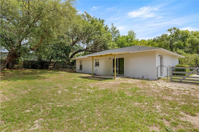 rear view of property featuring stucco siding and a patio