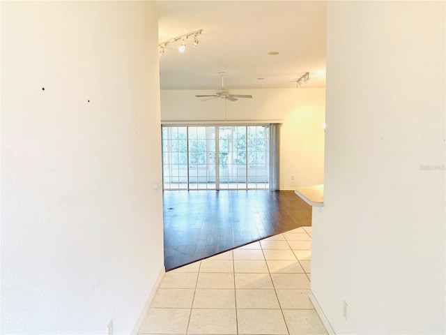1402 Arredondo Dr, The Villages, FL 32162 - hallway with light tile patterned flooring, baseboards, and track lighting