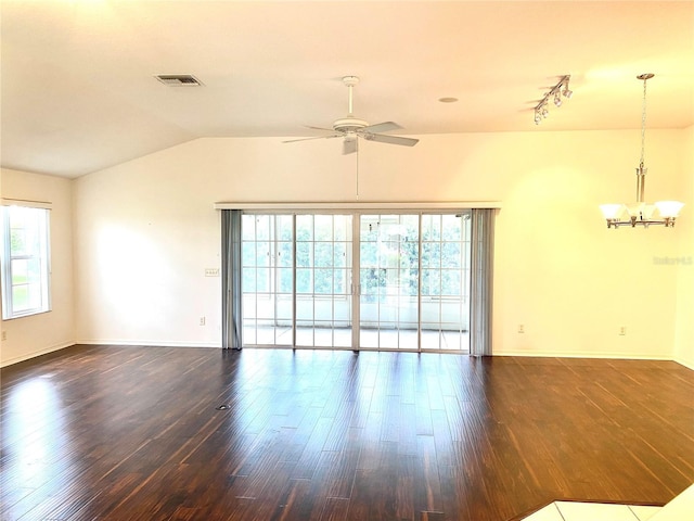 1402 Arredondo Dr, The Villages, FL 32162 - unfurnished room with healthy amount of natural light, dark wood finished floors, a chandelier, a ceiling fan, and vaulted ceiling
