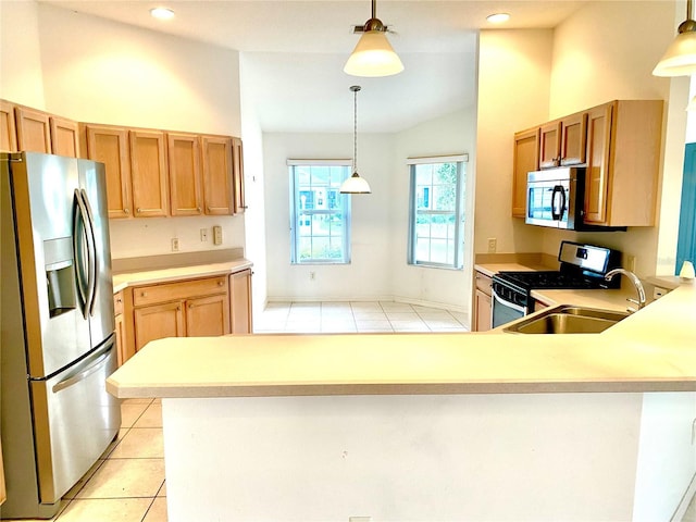 1402 Arredondo Dr, The Villages, FL 32162 - kitchen featuring appliances with stainless steel finishes, light countertops, light tile patterned floors, a peninsula, and pendant lighting