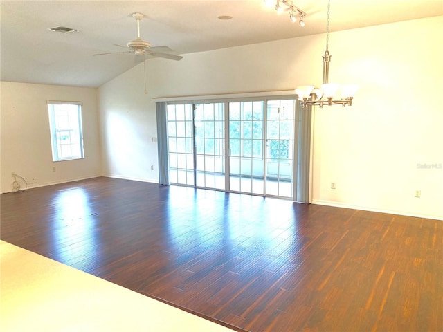 1402 Arredondo Dr, The Villages, FL 32162 - unfurnished room featuring a chandelier, dark wood finished floors, vaulted ceiling, a ceiling fan, and baseboards
