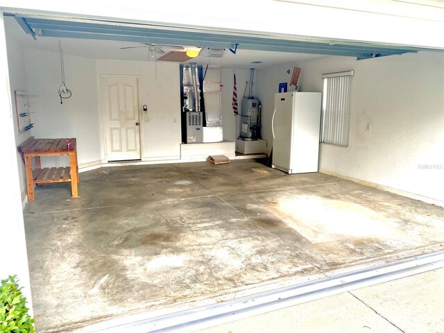 1402 Arredondo Dr, The Villages, FL 32162 - garage with freestanding refrigerator, water heater, heating unit, a garage door opener, and ceiling fan