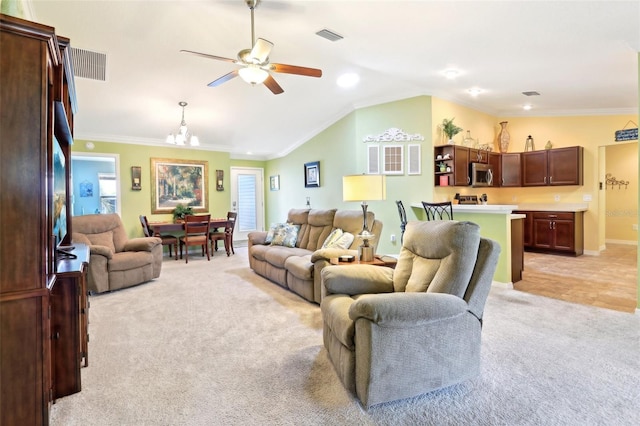 living area with light carpet, ceiling fan, a chandelier, ornamental molding, and lofted ceiling