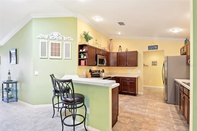 kitchen featuring stainless steel appliances, a peninsula, a kitchen breakfast bar, light countertops, and open shelves