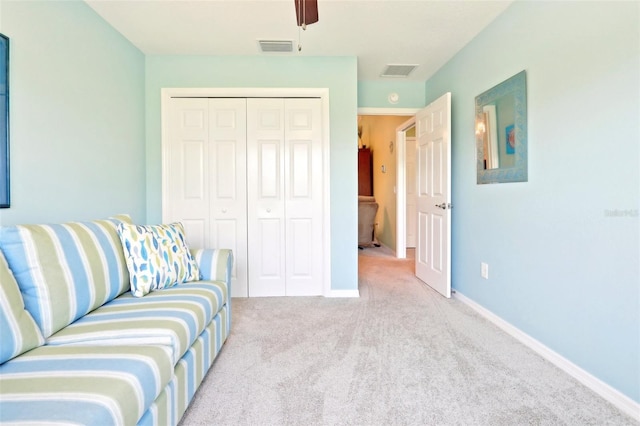 living room with carpet floors, baseboards, and a ceiling fan