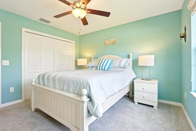 carpeted bedroom with baseboards, a closet, and a ceiling fan