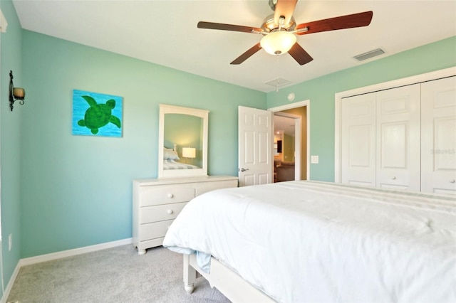 bedroom with light carpet, a closet, baseboards, and ceiling fan