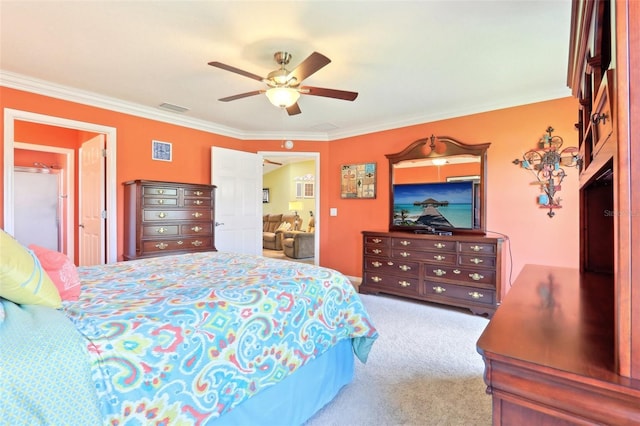 carpeted bedroom featuring crown molding and a ceiling fan