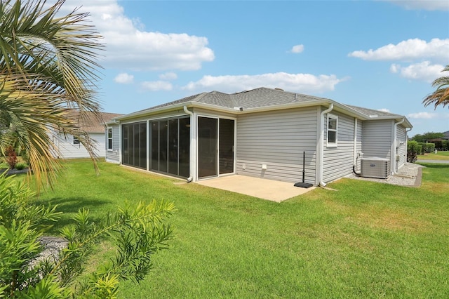 rear view of house featuring cooling unit, a yard, a sunroom, and a patio